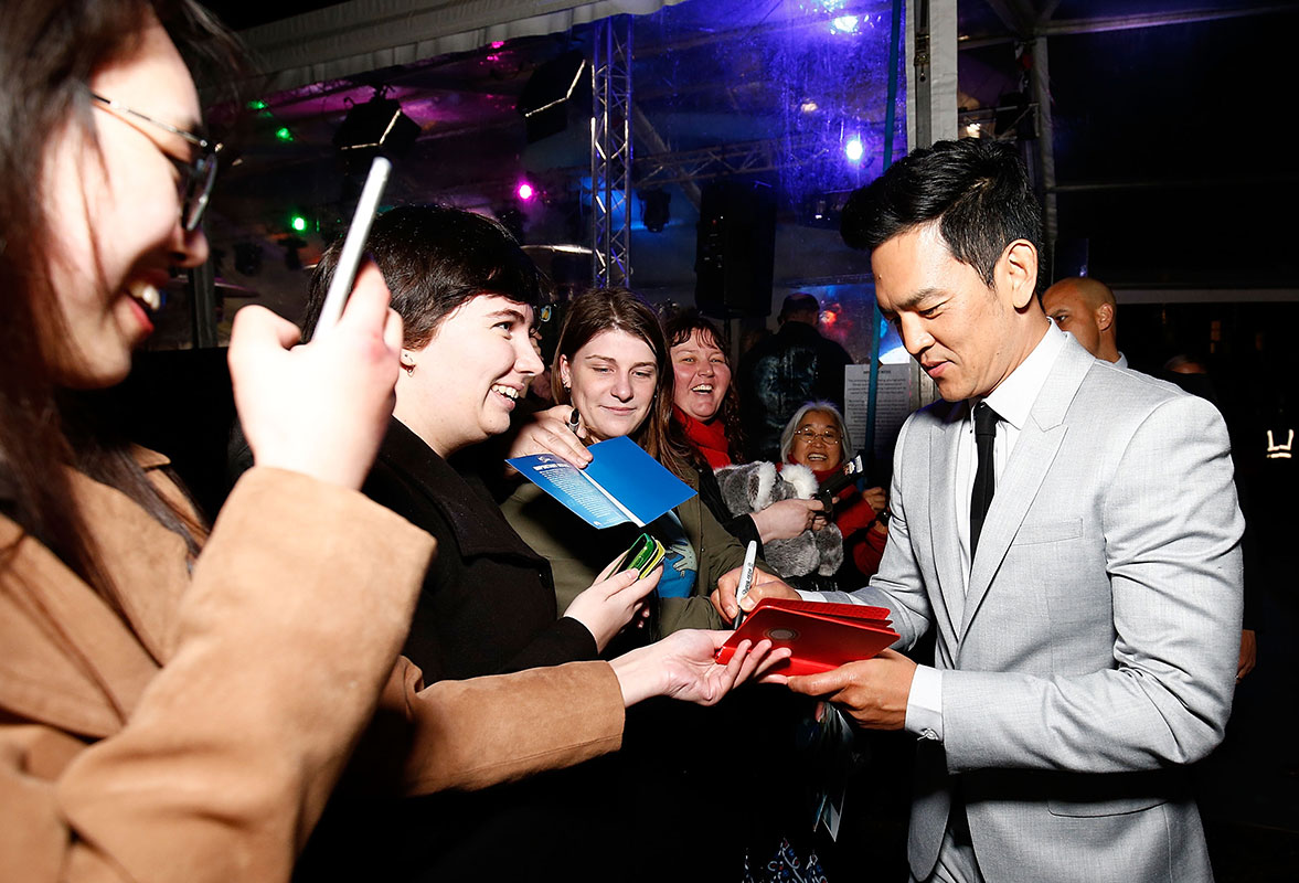 John Cho signs autographs for fans