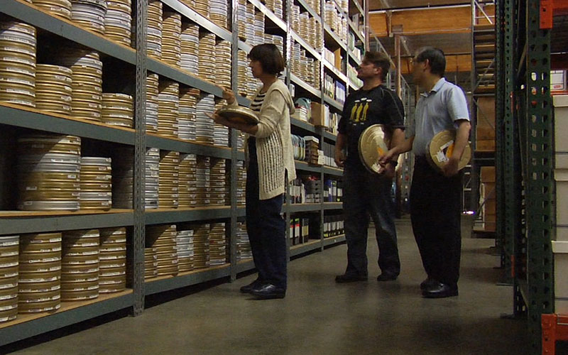 Denise Okuda, Rod Roddenberry and  Mike Okuda survey the reels of film