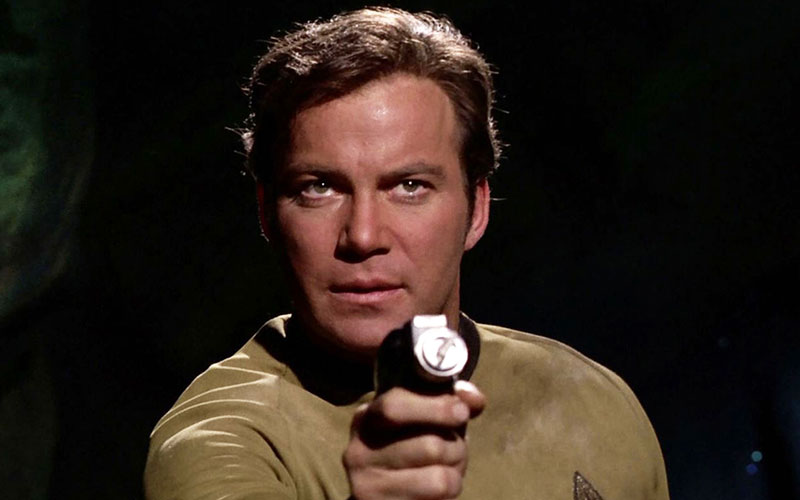 Captain James T. Kirk wielding his phaser