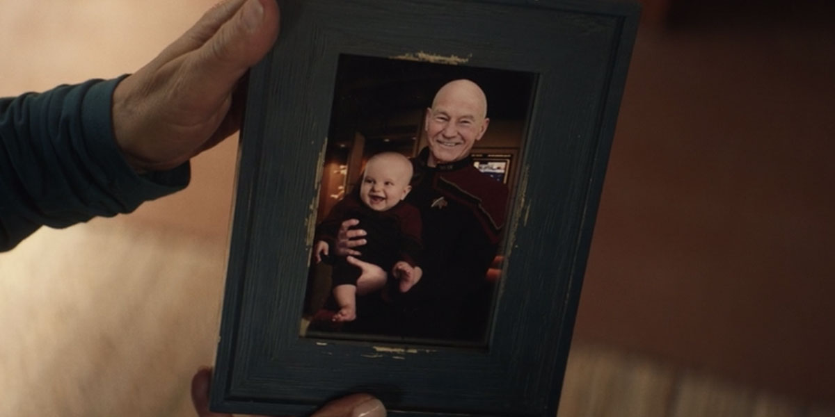 Troi holds a photo of Thad