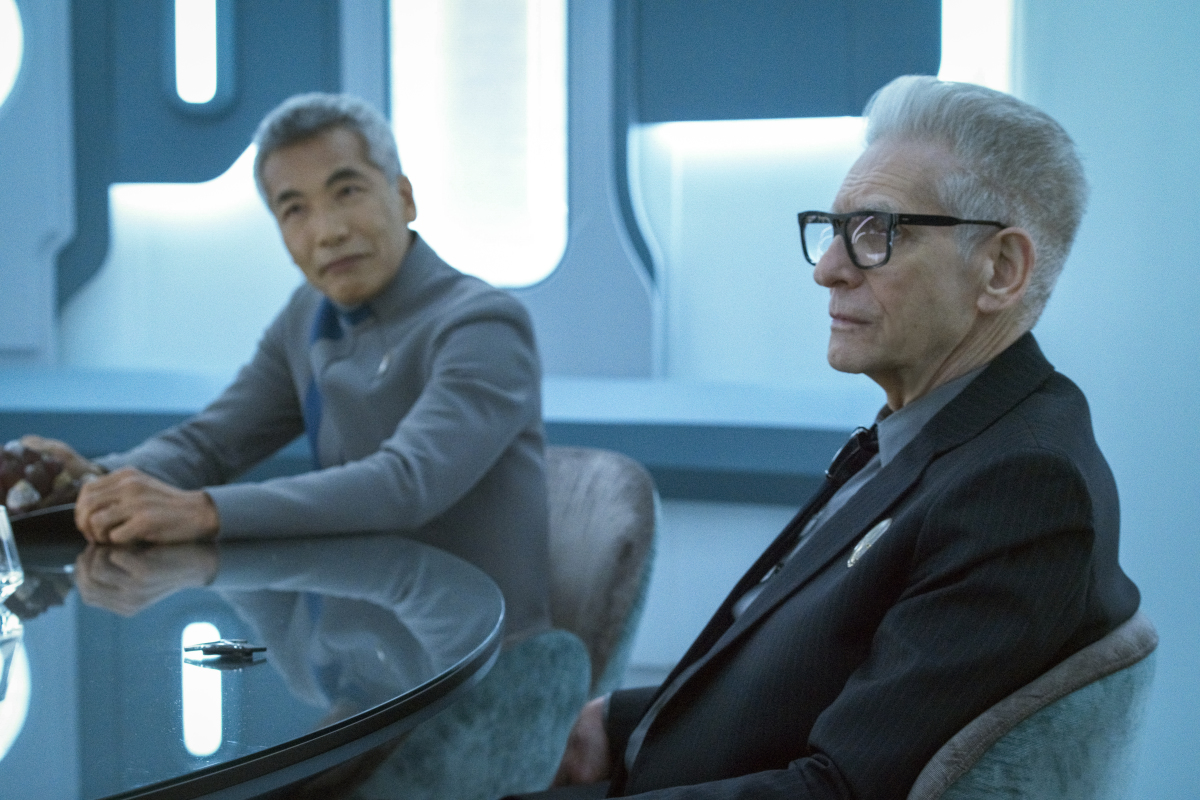 Hiro Kanagawa as Dr. Hirai and David Cronenberg as Kovich